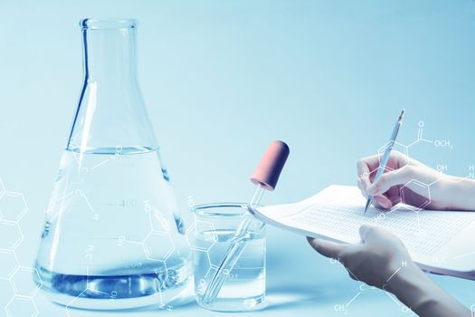 Researcher with glass laboratory chemical test tubes with liquid for analytical , medical, pharmaceutical and scientific research concept.