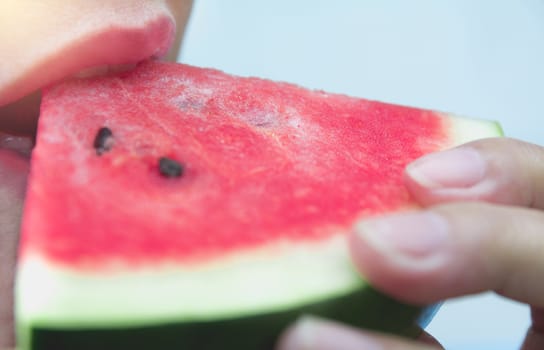 Woman eating watermelon. Portrait woman is holding slice of watermelon.