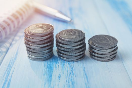 Saving money concept with money coin stack growing and note book for business and accounting concept.