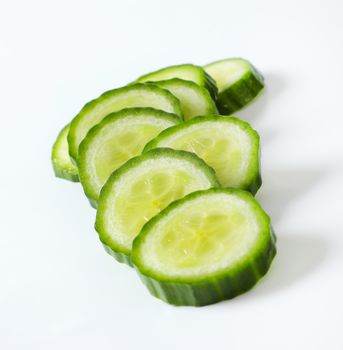 slices of green cucumber on white background - close up
