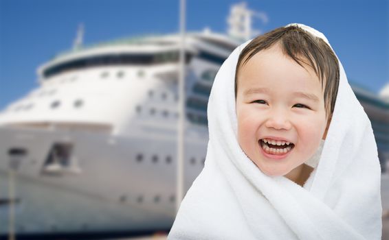 Happy Mixed Race Chinese and Caucasian Boy Near Cruise Ship Wrapped In A Towel.