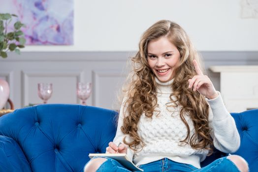 beautiful woman with a box on the couch posing