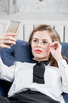 Lovely businesswoman with a phone in glasses