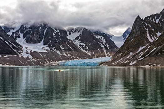 Dramatic sky at the end of the Magdalenafjord in Svalbard islands, Norway