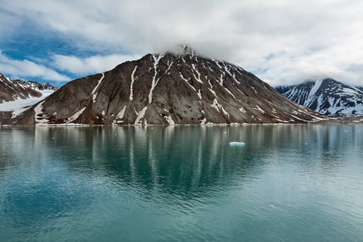 Clouds over the mountains along the Magdalenafjord in Svalbard islands, Norway