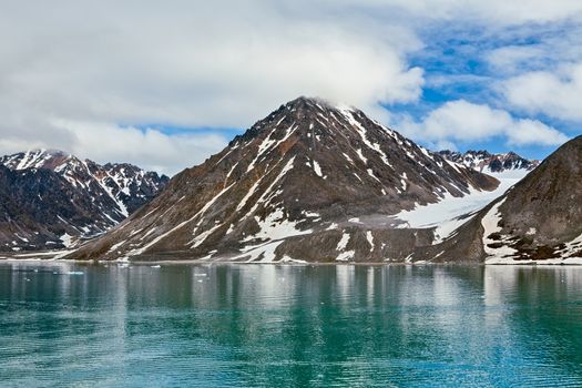 Clouds and mountains along the Magdalenafjord in Svalbard islands, Norway