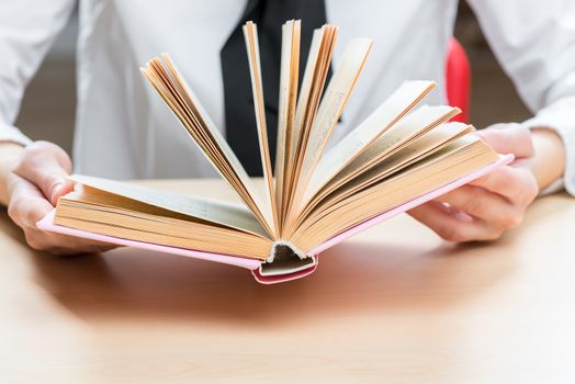 an open book an interesting novel in female hands closeup