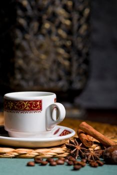 a beautiful cup of coffee, anise and cinnamon still life on the table