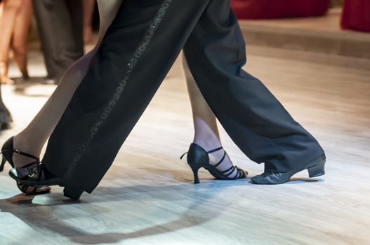 legs of a couple who dance in competition