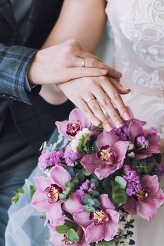 Wedding bouquet in the hands of the bride. Round wedding bouquet of pink flowers.