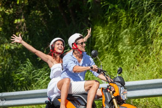 Happy couple on a scooter at summer vacation