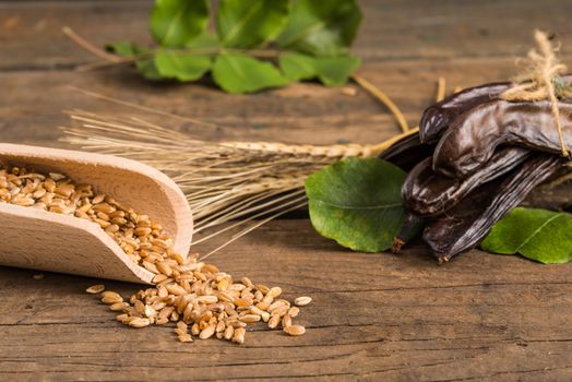 Raw fruits Carob on old wooden background
