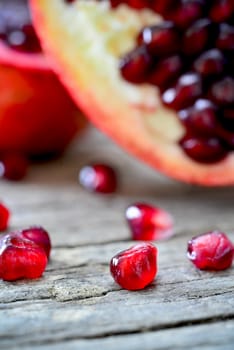 closeup of a pomegranate on a rustic wooden table