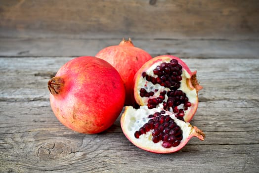 closeup of a pomegranate on a rustic wooden table