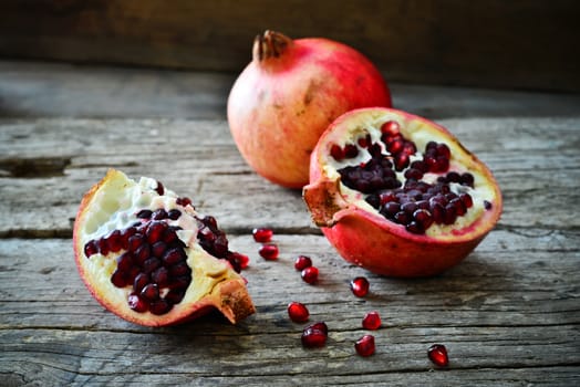 closeup of a pomegranate on a rustic wooden table