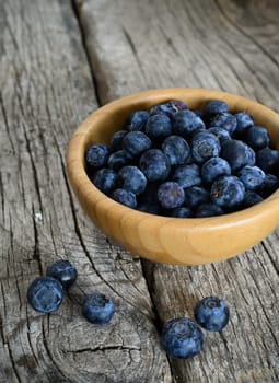 Organic blueberries on a rustic wooden table