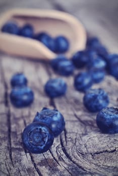 Organic blueberries on a rustic wooden table.