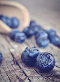 Organic blueberries on a rustic wooden table. 