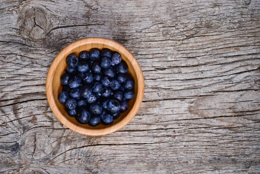 Organic blueberries on a rustic wooden table