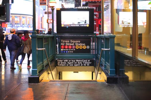 New York, New York, USA - May 20, 2013: An entrance to the Times Square 42nd Street Subway Station located on the corner of 7th Avenue and 40th street in New York City. Pedestrians can be seen.