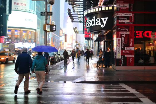 New York, USA - May 20, 2013: Time Square at night in the rain. The site is regarded as the world's most visited tourist attraction with nearly 40 million visitors annually.