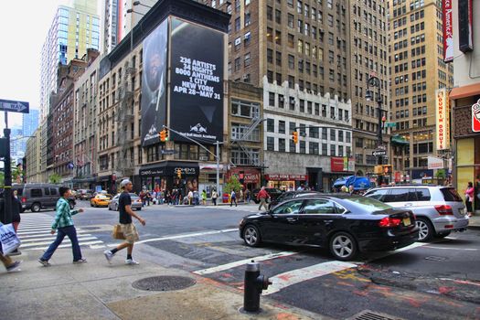 New York City, NY, USA - May 19, 2013: Times Square, featured with Broadway Theaters and huge number of LED signs, is a symbol of New York City and the United States, May 19, 2013 in Manhattan, New York City