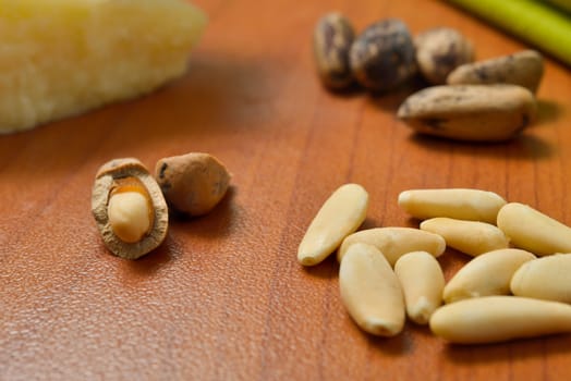 Some fresh Pine Nuts on dark wooden background.
