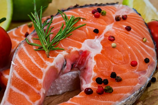 fresh salmon with rosemary, tomatoes, pepper and lemon