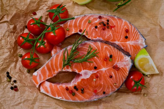 fresh salmon with rosemary, tomatoes, pepper and lemon
