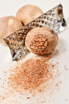 Nutmeg whole and powder isolated on white background