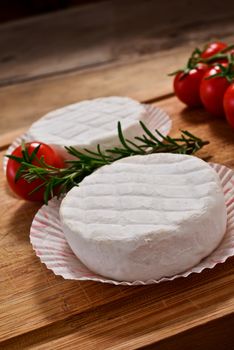 Italian tomino cheese on a wooden chopping board, italian appetizer