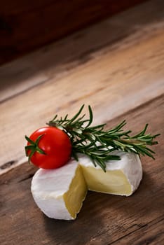 Italian tomino cheese on a wooden chopping board, italian appetizer