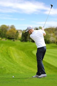 Caucasian bearded golfer hit a golf ball by golf-club driver