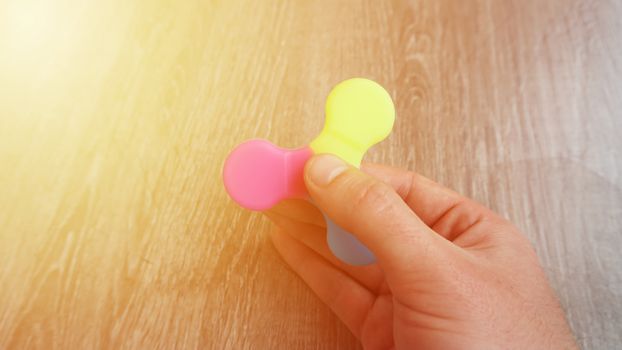 Playing with the colorful Fidget Spinner. Toy