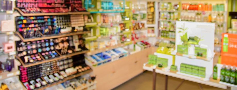 Blurred view on perfumery at retail store in Europe. Perfumery in local supermarket, defocused background.