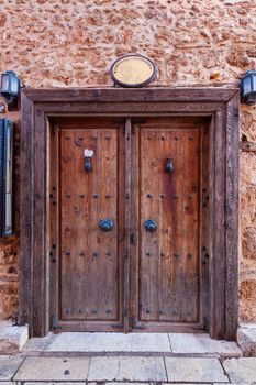 Old grunge wooden door with two hanging lights on both sides