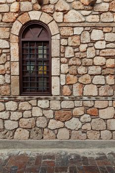Ancient stone wall with wooden windows in Turkey