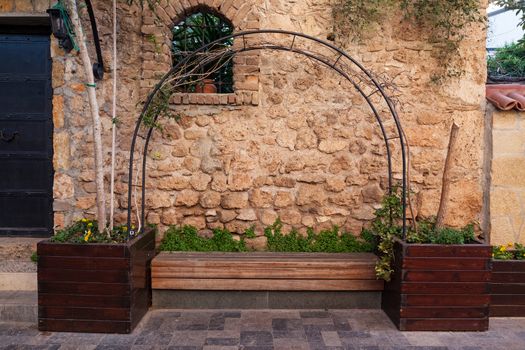 Bench in a picturesque location with a stone wall background