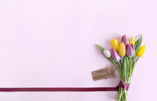 Silk ribbon attached to a bunch of flowers with label