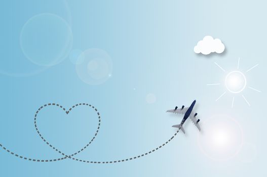 Miniature plane with heart shape trail on sky paper background with illustration of sun, clouds and birds 
