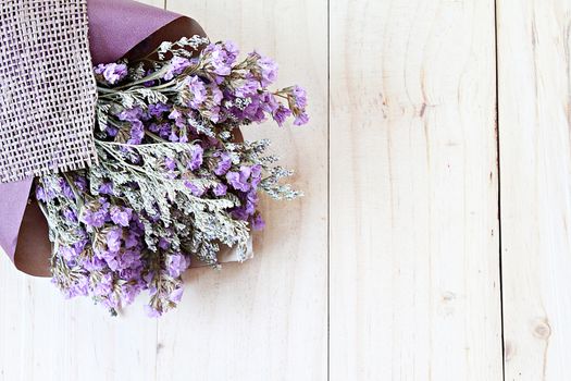 Nature or background concept : Bouquet of dried wild flowers on wooden background with copy space, top view or flat lay, ready for adding or mock up