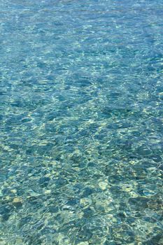 Beautiful background of crystal clear transparent sea water at sunny day