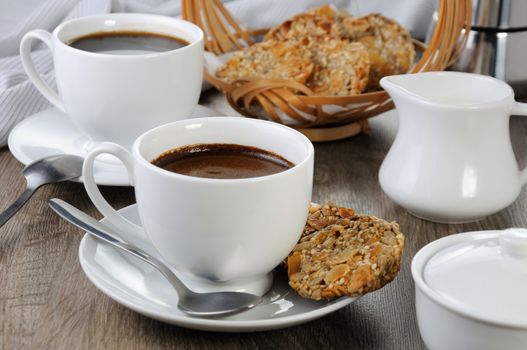 A cup of coffee with gluten-free cookies from cereals on the coffee table. It's time have a bite