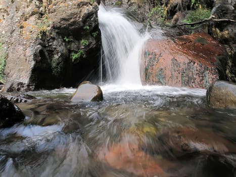 mountain water fell on red stone
