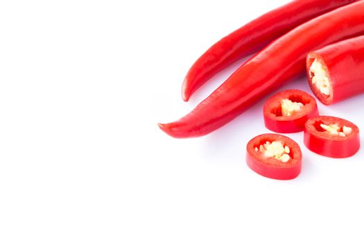 Closeup top red chili pepper with sliced on white background, raw food ingredient concept