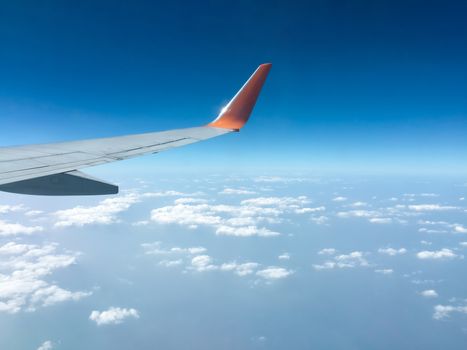 Top view sky and clouds looking from window airplane flying, nature background concept