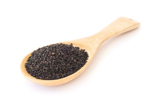 Black sesame on wooden spoon with white background, healthy food concept