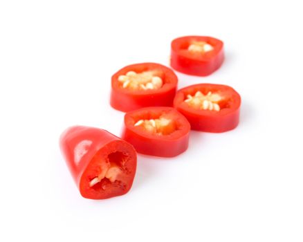 Closeup top red chili pepper with sliced on white background, raw food ingredient concept