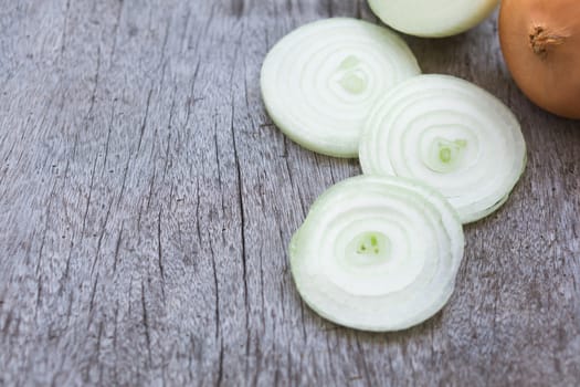 Closeup onion sliced on wood background, food ingredient concept, selective focus