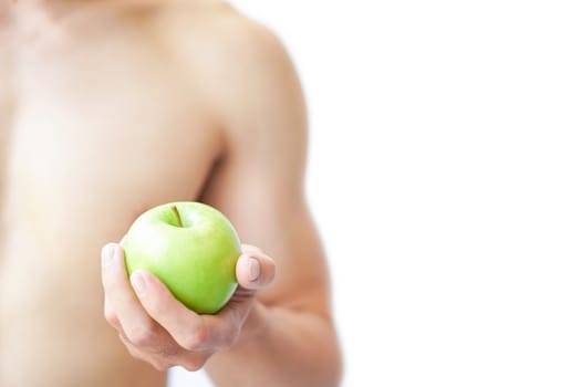 Closeup man hand holding green apple with muscle on white background, health care and medical concept, selective focus